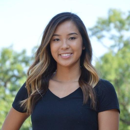 Young woman smiling on campus.